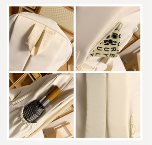 Detail view of the multi-compartment storage and anti-theft zipper of the cream white backpack