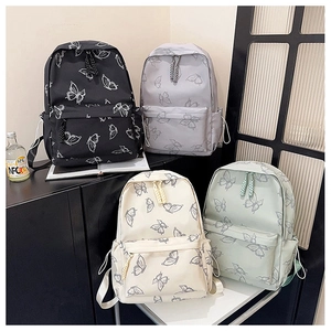 Detailed view of four butterfly print backpacks in black, grey, beige and light green tones