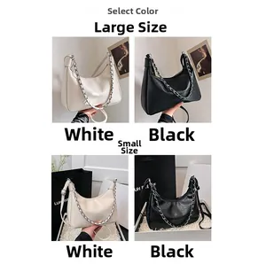 Close-up of large and small tote bags in black and white with thick silver chain detail