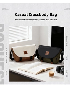 Close-up of canvas messenger bags in color-block design with leather buckles and wide straps