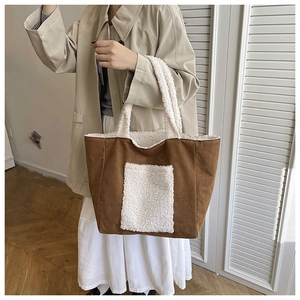 Detail of plush tote bag with contrasting brown suede and white fleece patchwork trim