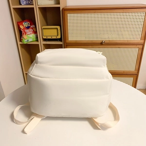 Minimalist white quilted backpack for students with large capacity and soft puff design