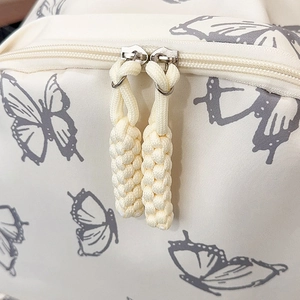Beige butterfly print backpack featuring premium double zippers and woven rope pulls