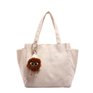 Minimalist beige corduroy tote bag for women with a brown plush doll charm