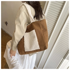 Detail of caramel suede tote bag with white fleece shoulder straps and soft fuzzy textures