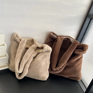 Close-up of plush fleece texture on beige and coffee brown large tote shoulder bags