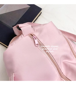 Detail of smooth pink nylon zipper and adjustable buckle on the fitness yoga bag
