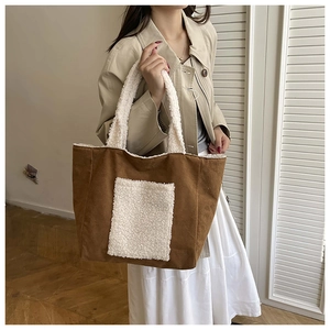 Detail of the brown corduroy tote bag featuring plush white faux fur front pocket and handles