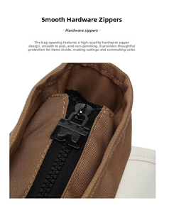 Detailed close-up of the smooth black metal hardware zipper on a brown canvas messenger bag