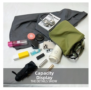 Top-down macro view showing large capacity of the green nylon crossbody bag with daily essentials
