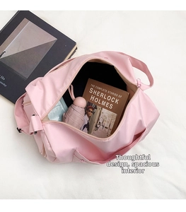 Interior detail of a pink nylon tote bag showing spacious capacity for books and umbrella