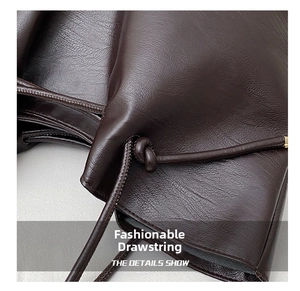Detailed macro view of deep brown leather tote featuring stylish drawstring and knot detail