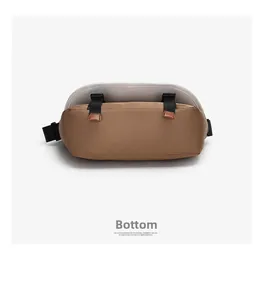 Detail view of the durable bottom with adjustable straps on this earth-tone messenger bag