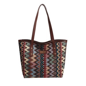 Ethnic bohemian woven tote bag with colorful geometric patterns and leather handles