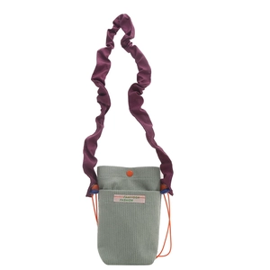 Retro corduroy crossbody phone bag with purple ruffled strap and contrast colors