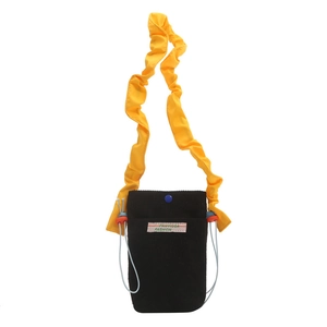 Mini black corduroy crossbody bag with yellow ruffled strap and blue snap closure