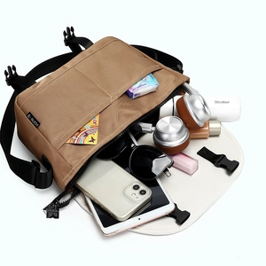 Khaki large capacity crossbody messenger bag showing multi-pocket storage for tablets