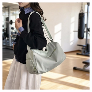 Close-up of mint green gym bag with waterproof nylon texture and side shoe compartment