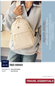 Close-up of lightweight beige nylon backpack featuring dual zippers and side pockets