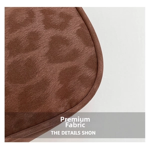 Macro shot of brown suede fabric with leopard print texture on a chic shoulder bag