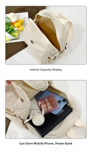 Detail view of the spacious inner compartment of the beige nylon backpack showing storage