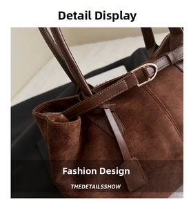 Close-up of brown faux suede tote bag with gold metal D-ring buckle and fine stitching