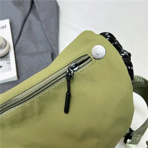 Large capacity light green nylon crossbody bag showing durable tear-resistant texture