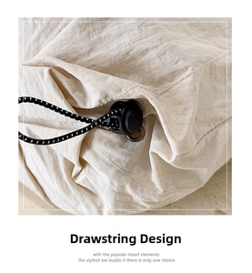 Close-up of adjustable drawstring feature with black toggle on beige nylon tote bag