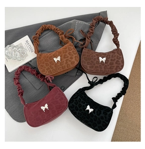 Detail of leopard print hobo bags with butterfly metal piece and pleated straps in four colors