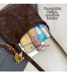 Detail view of large dark brown crossbody bag interior showing spacious storage capacity