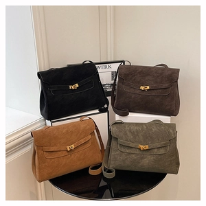 Four large suede shoulder bags with metal buckles in black, brown, tan, and olive green