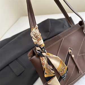 Brown large-capacity leather tote bag with contrast stitching and floral silk scarf