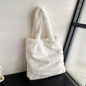 Detailed texture of white faux fur tote bag with soft fluffy material for autumn winter