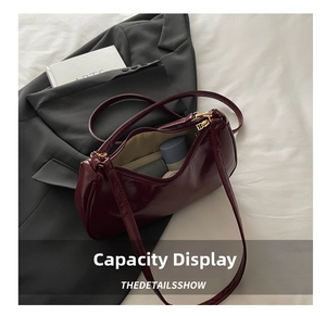 Macro view of burgundy baguette bag interior showing spacious storage capacity