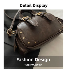 Detail view of vintage dark brown bowling bag featuring textured leather and gold studs