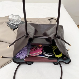Retro brown leather tote bag showing large capacity for daily commute essentials