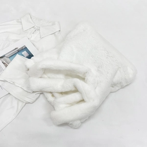 White faux fur plush tote bag with gold decorative buckle for winter fashion styling