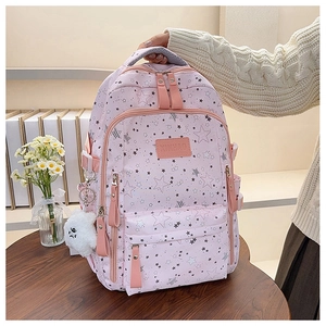 Close-up of pink star pattern school bag with plush cloud pendant and logo detail