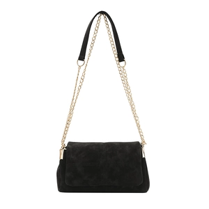 Minimalist black suede crossbody bag with square quilted patterns and gold chain strap
