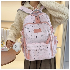 Detail of pink backpack with star patterns and cloud plush pendant for school girls