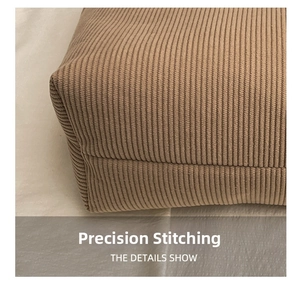 Macro detail of high-quality corduroy fabric texture and precision stitching on khaki tote bag