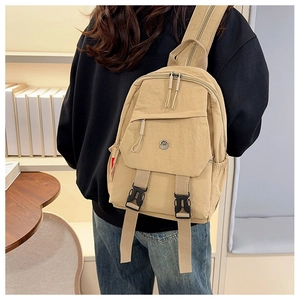 Detail view of khaki multifunctional backpack featuring nylon pockets and black buckles