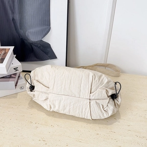 Large capacity off-white nylon cloud tote bag with adjustable black drawstring detail