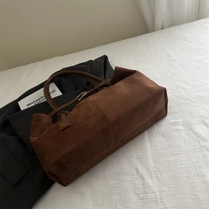Retro dark brown large suede tote bag on bed with blazer for chic casual commuting