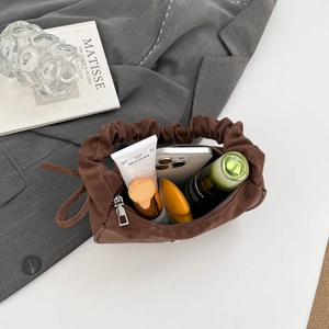 Brown PU leather bag with pleated handle showing spacious interior for daily essentials