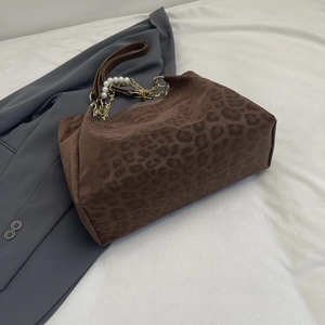 Brown leopard print oversized tote bag with pearl chain straps and leather shoulder handles