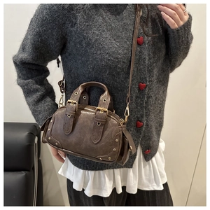 Brown vintage leather crossbody bag with golden studs and retro buckle details
