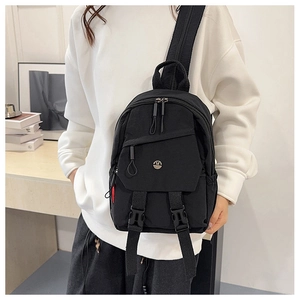 Close-up of durable black nylon chest bag with adjustable buckles and multiple zippers