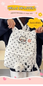 Close-up of white kitten backpack with star patterns and cute cat ears detail
