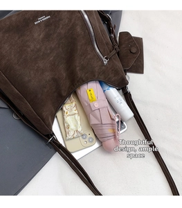 Deep brown matte shoulder bag with large capacity showing umbrella, phone, and daily essentials